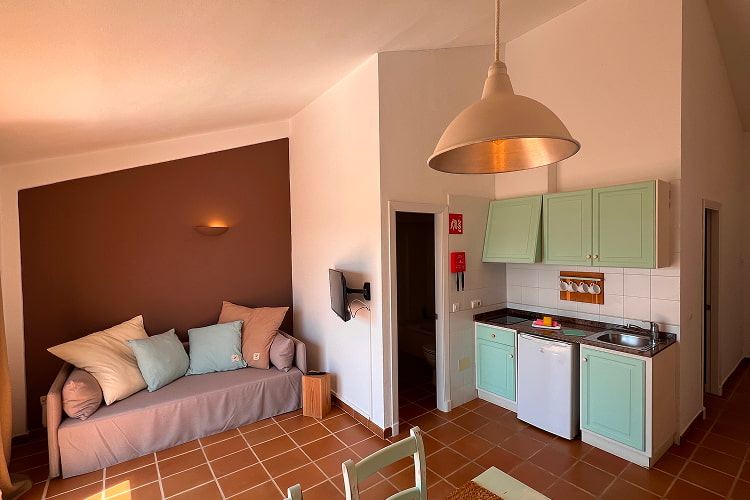 Full apartment with kitchen and living room Apartment with sofa, kitchen, table and chairs.