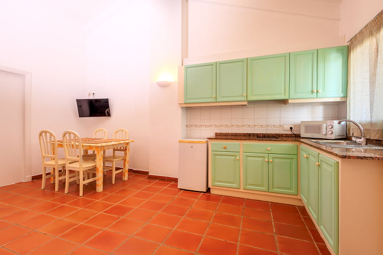 Apartment - Kitchen Spacious kitchen in sea water colour with dining table and TV
