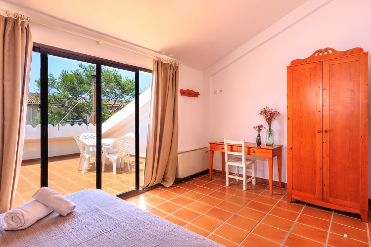 Apartment - Bedroom Large bedroom with wardrobe, desk and access to the terrace.