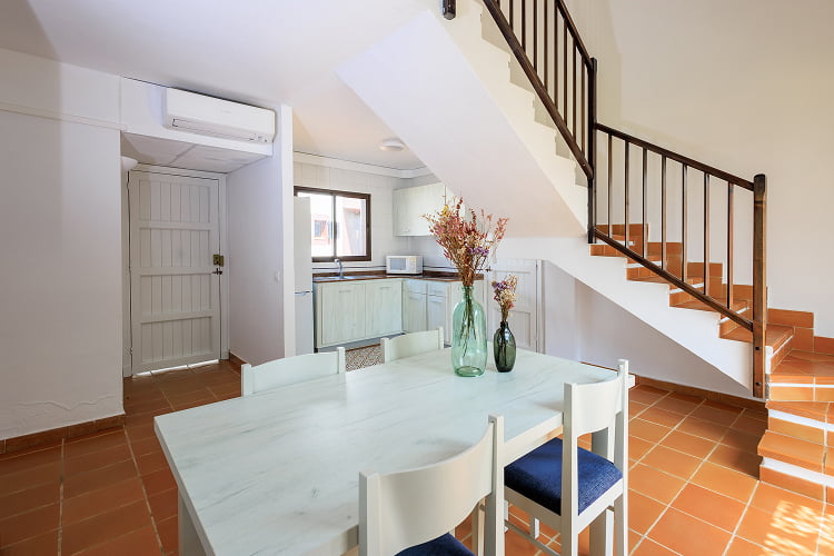 Duplex - Living room Dining table with kitchen open to the living room at the back