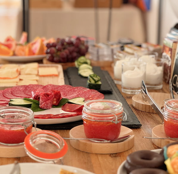 Breakfast with local flavour Nuramar Full breakfast table with toasts, cold meats, cheeses, sweets...